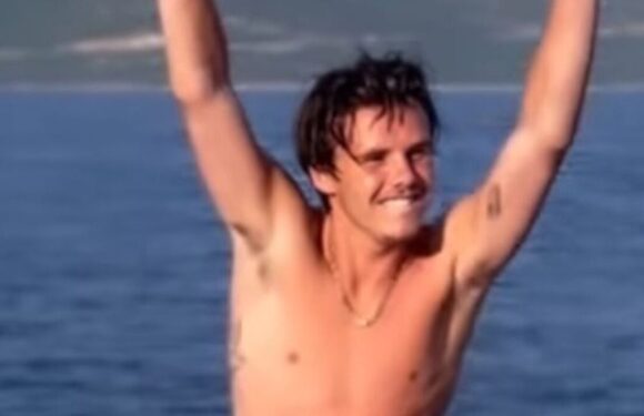 Cruz Beckham is the spitting image of dad David Beckham as he enjoys boat trip