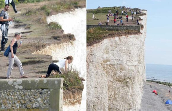 Idiot tourists pose for selfies and teenagers hang over 150ft cliff at Birling gap as adults WATCH | The Sun