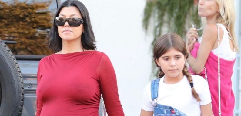 Kourtney Kardashian flaunts baby bump in skintight red dress on day out with daughter Penelope