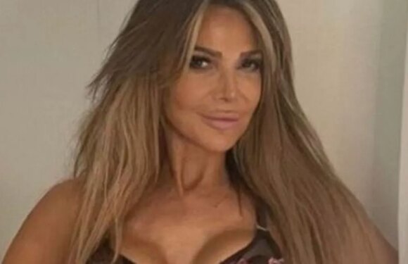 Lizzie Cundy shows off her toned figure as she models floral embroidered lingerie