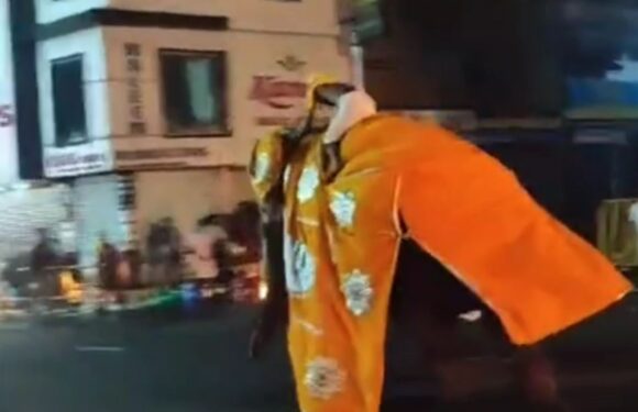 Terrifying moment angry elephant goes berserk at Buddhist parade as pilgrims run for their lives jumping into water | The Sun