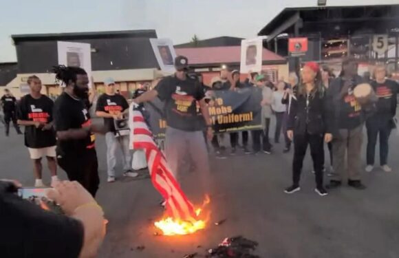 Communist revolutionaries burn American flags in protest at controversial singer