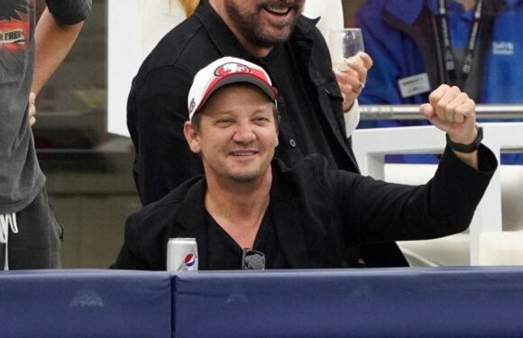 Jeremy Renner cheers at NFL game nine months after near-death accident