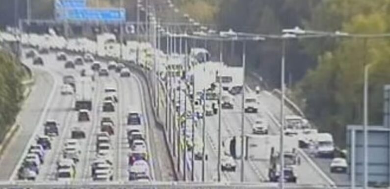 M25 accident: Lorry overturns in crash involving VW Passat and Ford Fiesta – as motorway suffers tailbacks | The Sun