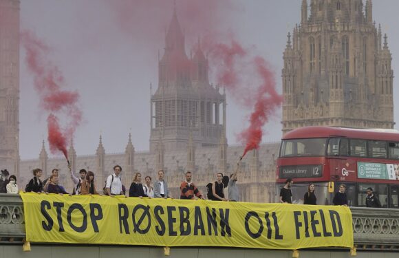 Protesters light flares on Westminster Bridge over Rosebank oil field