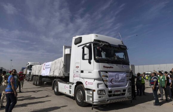 Aid trucks flow into besieged Gaza from Egypt after border deal as Israel tanks and 300k troops loom for invasion | The Sun