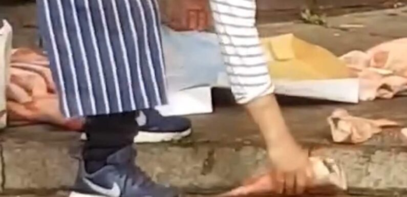 Moment fishmonger throws frozen seafood down onto the pavement