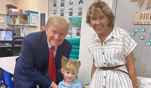 Donald Trump holds granddaughter Carolina's hand at school