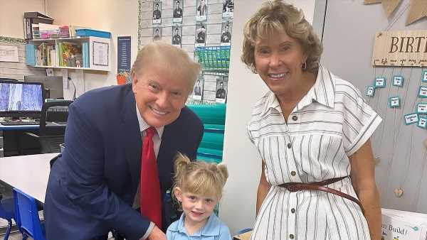Donald Trump holds granddaughter Carolina's hand at school