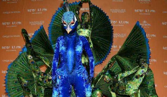 Heidi Klum dresses up as a PEACOCK at her annual party extravaganza