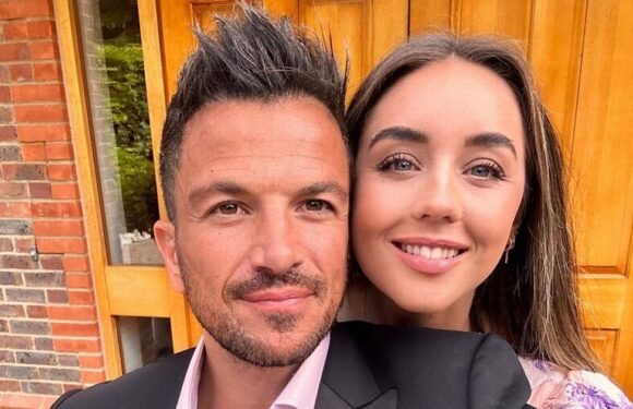 Pregnant Emily Andre and husband Peter sweetly cradle bump as baby is ‘kicking like mad’