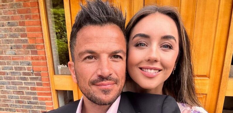 Pregnant Emily Andre and husband Peter sweetly cradle bump as baby is ‘kicking like mad’