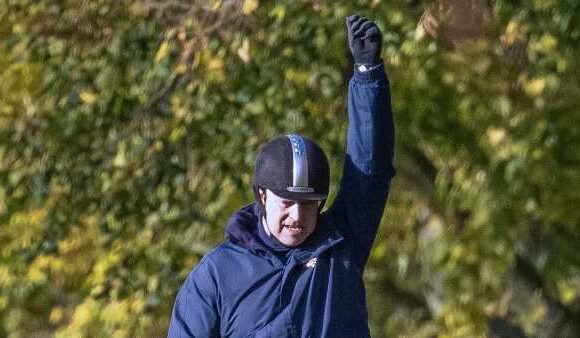 Prince Andrew punches the air as he goes for  horseride in Windsor