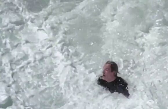 Surfer pounded by huge waves before Bondi Rescue guard helps him