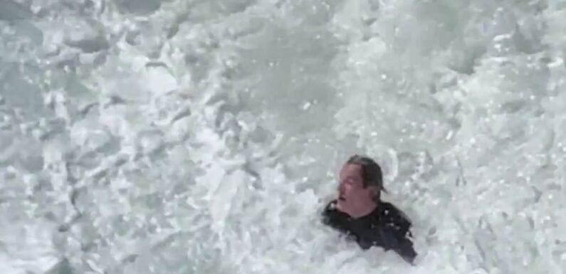 Surfer pounded by huge waves before Bondi Rescue guard helps him