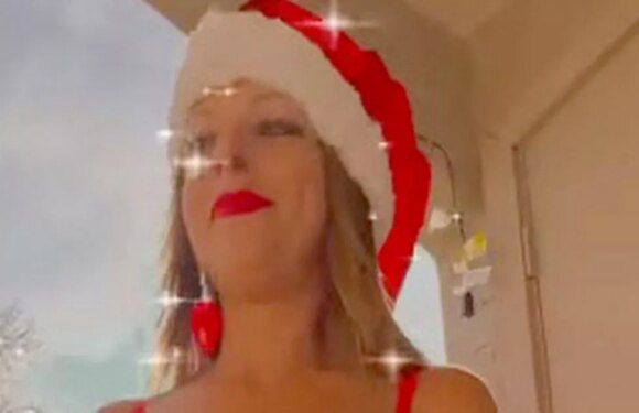 Proud cougar dons Mrs Claus outfit as she flashes lingerie on balcony