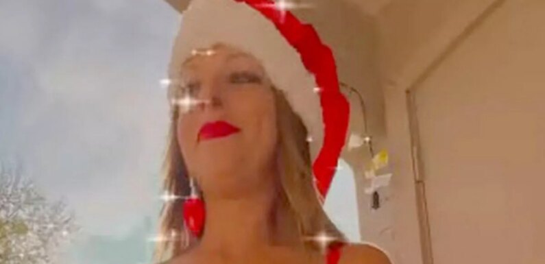 Proud cougar dons Mrs Claus outfit as she flashes lingerie on balcony